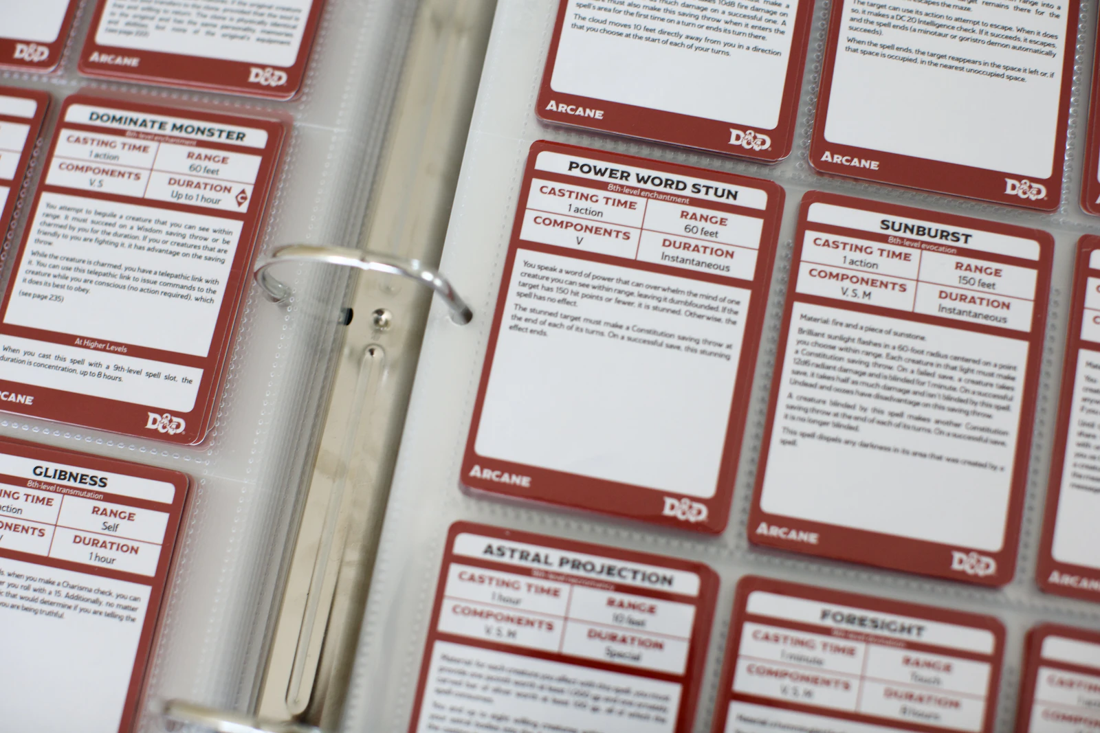 Sheets of 5e spell cards in a binder